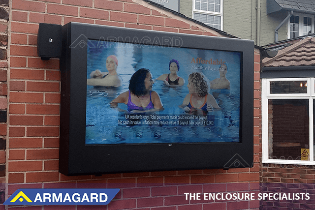 Wall mounted landscape outdoor TV enclosure installed in a garden